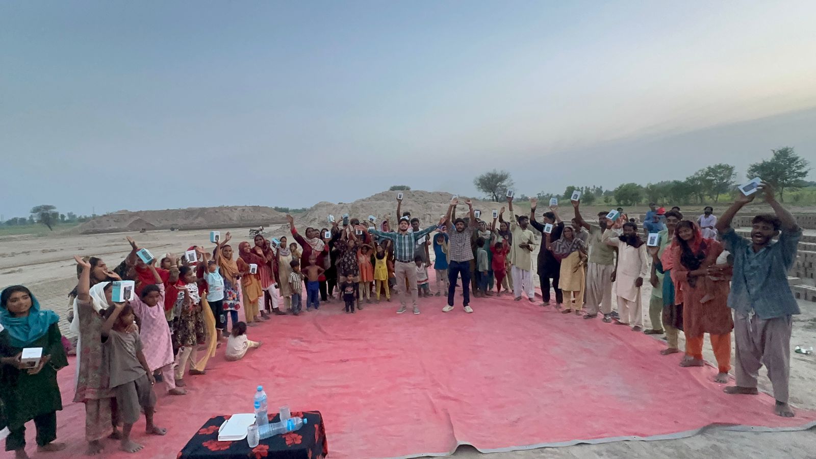 Community in Pakistan holding audio Bibles received from SiC Ministry